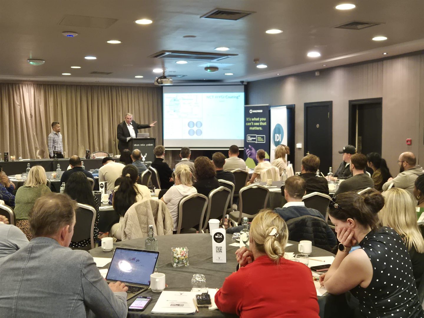 A full room of delegates watches a Study Day session.