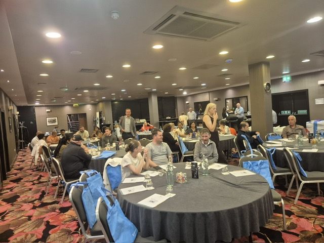 Delegates take their places around the conference tables.