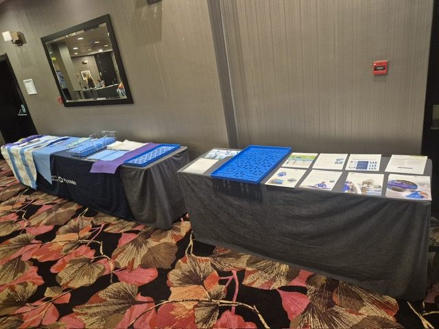 Sponsor information and materials arranged at an exhibitor table.