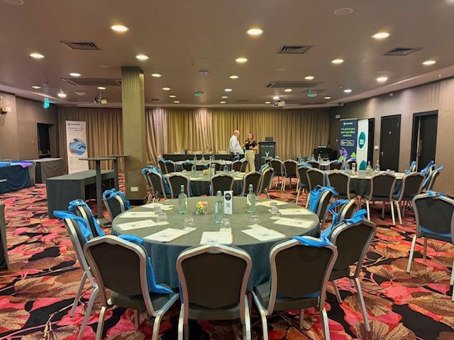 Conference tables and chairs arranged before the sessions.